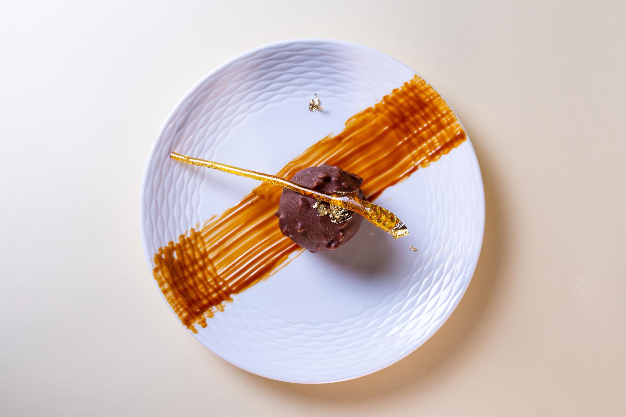 Close-up of plated dessert with gold leaf